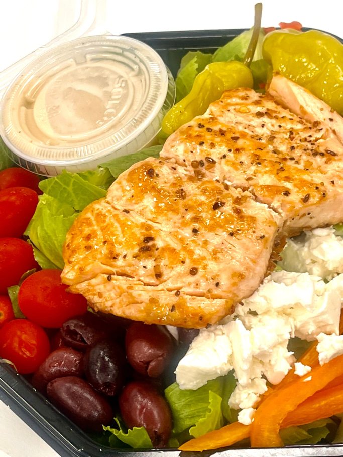 Grilled salmon atop mixed greens, cherry tomatoes, olives, house dressing.